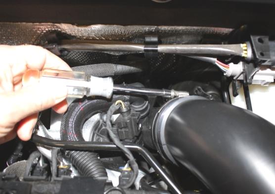 Disconnect air intake hose at turbo inlet using 7mm nut driver.